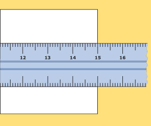 Section of ruler on top of a piece of card. The scale is numbered 12, 13, 14, 15, 16, with ten small unlabelled divisions in between each number. The edge of the card lines up with 15.