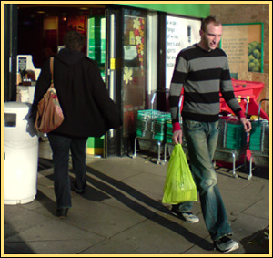 Person with carrier bag of shopping.